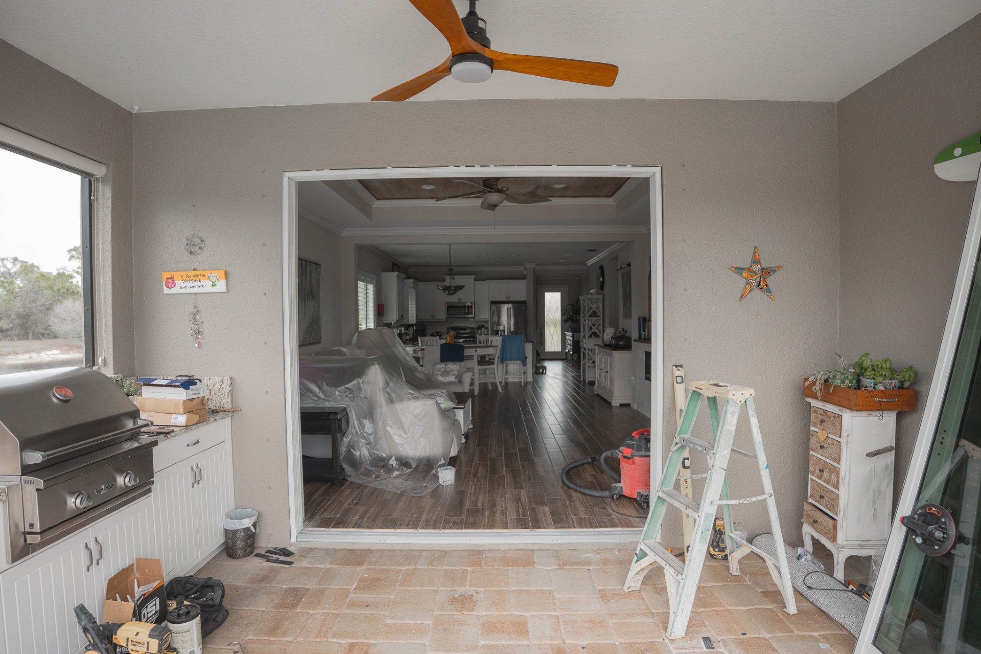 Large impact slider opening from lanai to living room — Southwest Florida home