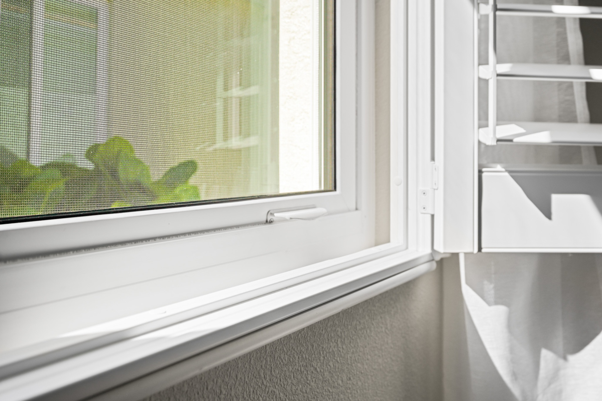 Close-up of impact casement window with screen
