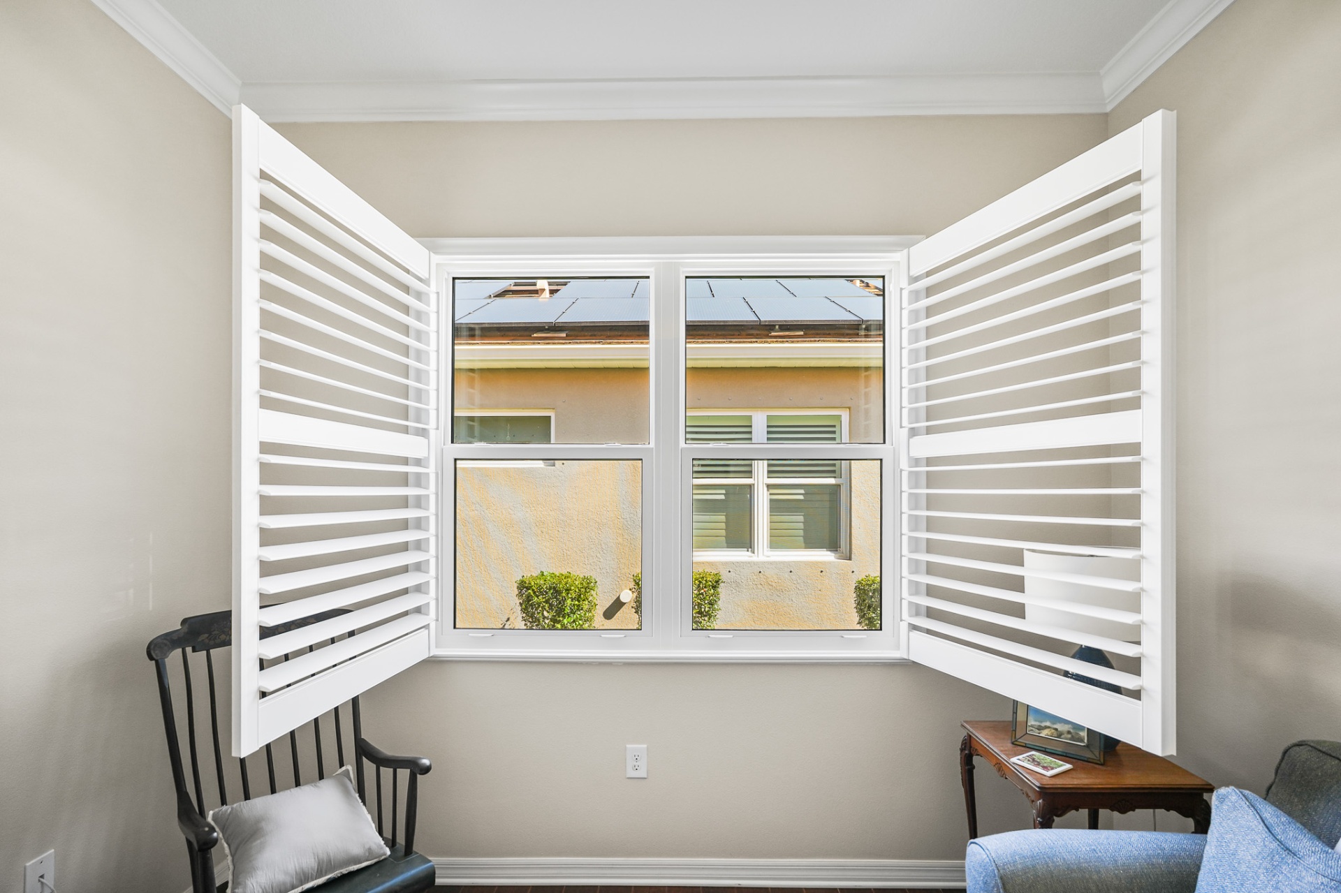 Double-hung impact windows with open plantation shutters