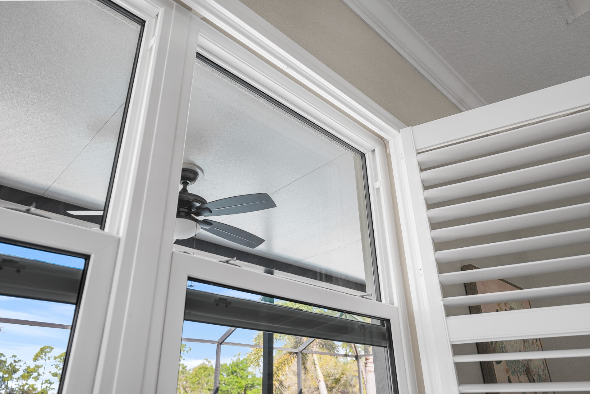 Detail of corner impact windows with plantation shutters