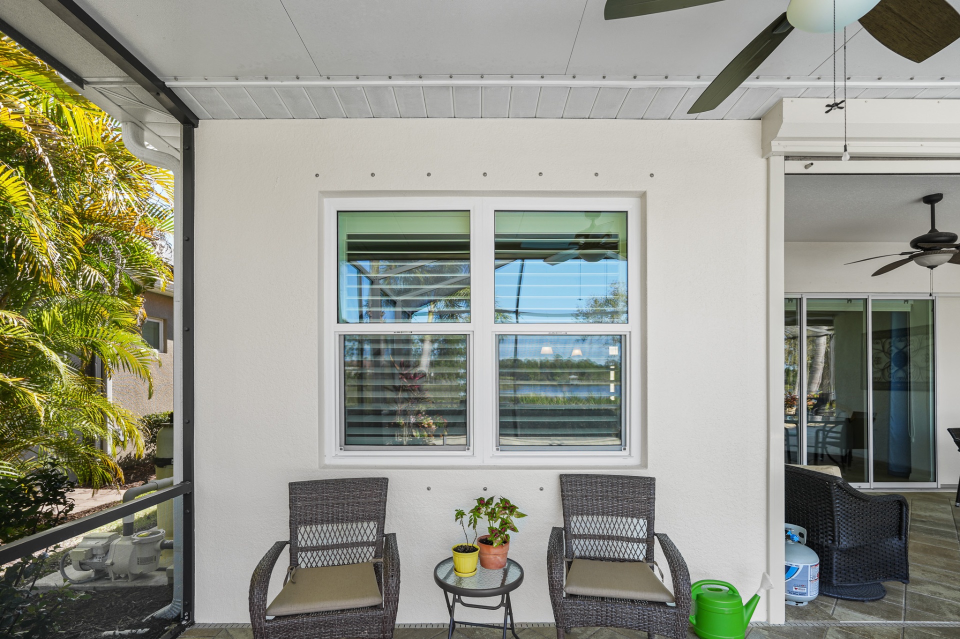 Lakefront lanai with new impact windows and seating area