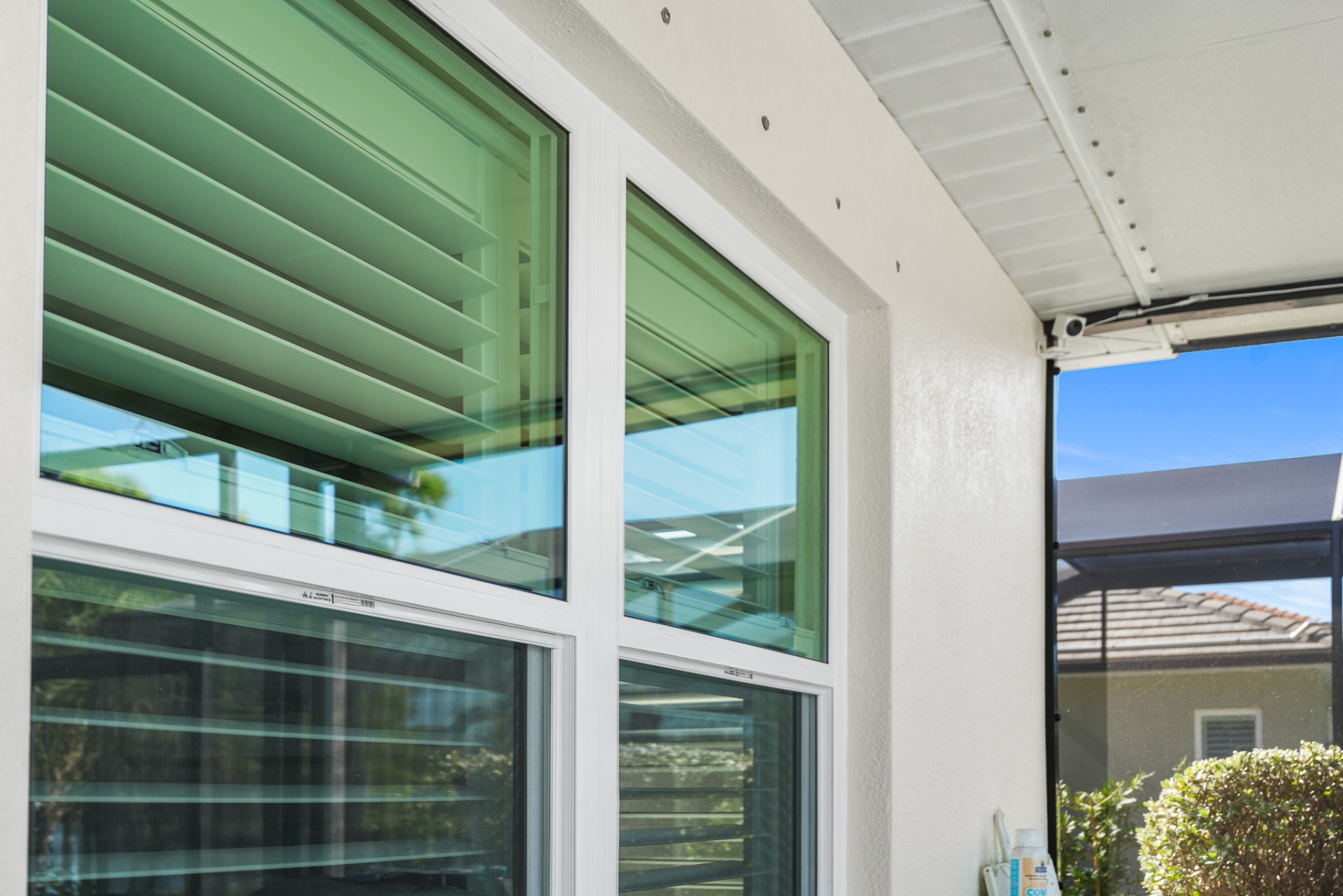 Close-up of impact window installation on covered patio