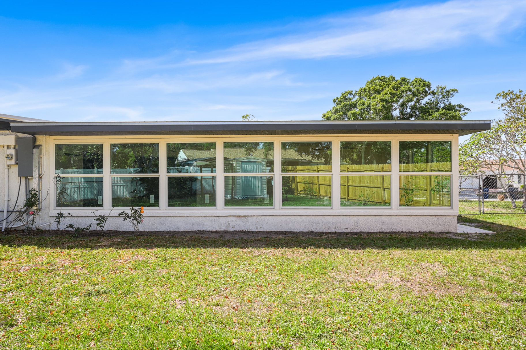 Florida room enclosure with full wall of new impact windows