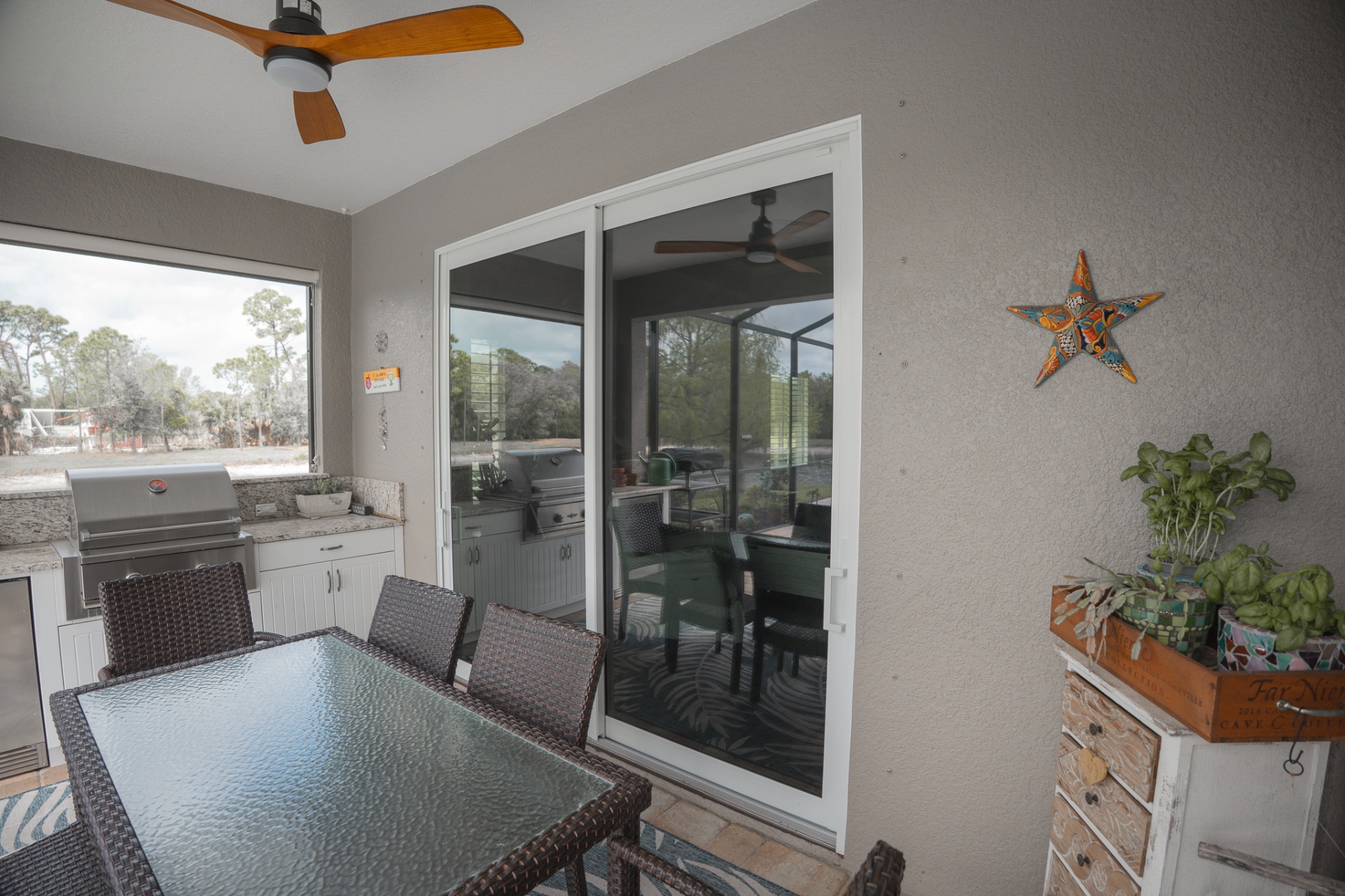 Outdoor lanai with new impact sliders leading to screened pool area