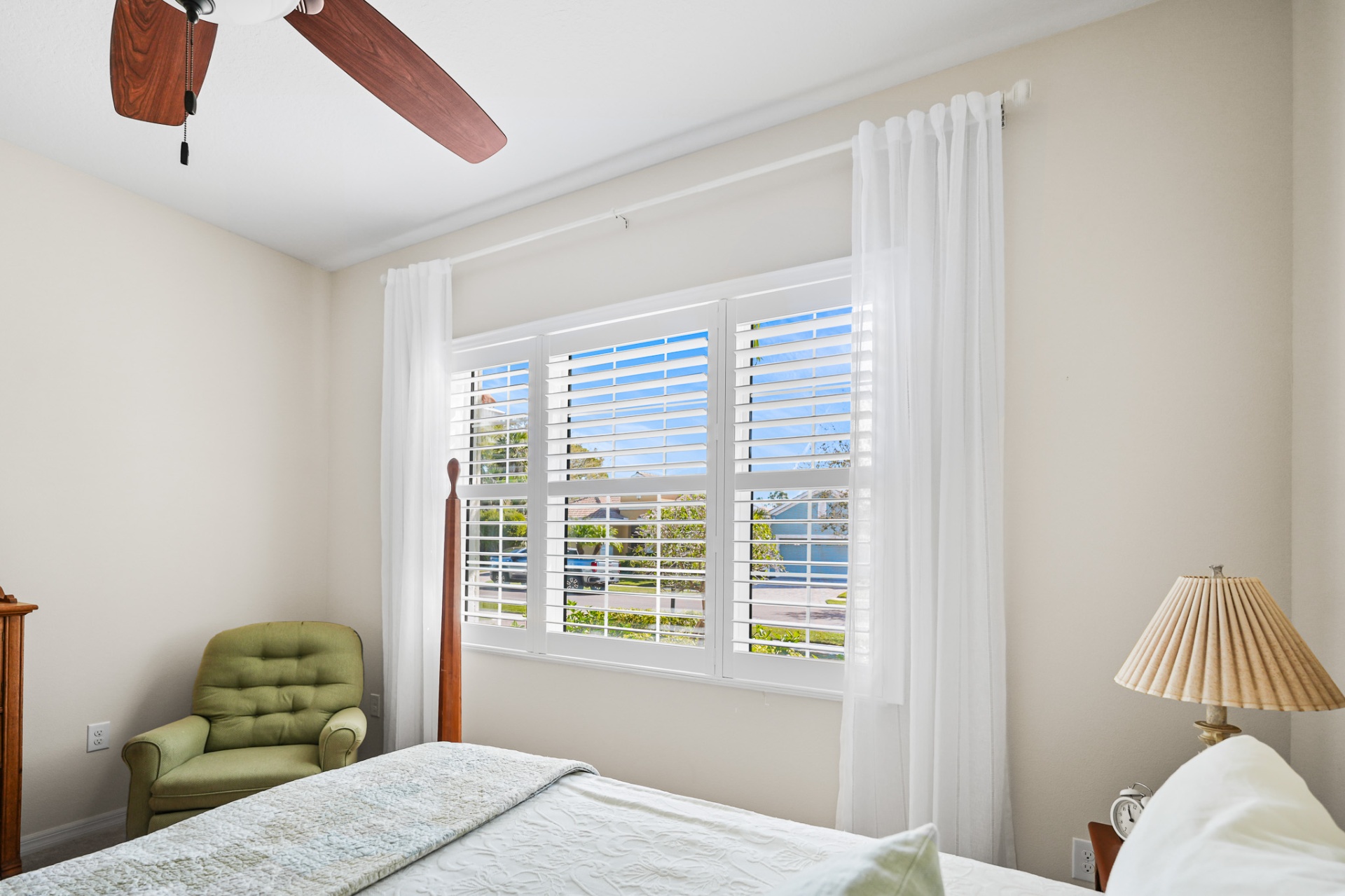 Bedroom with impact-rated windows and plantation shutters