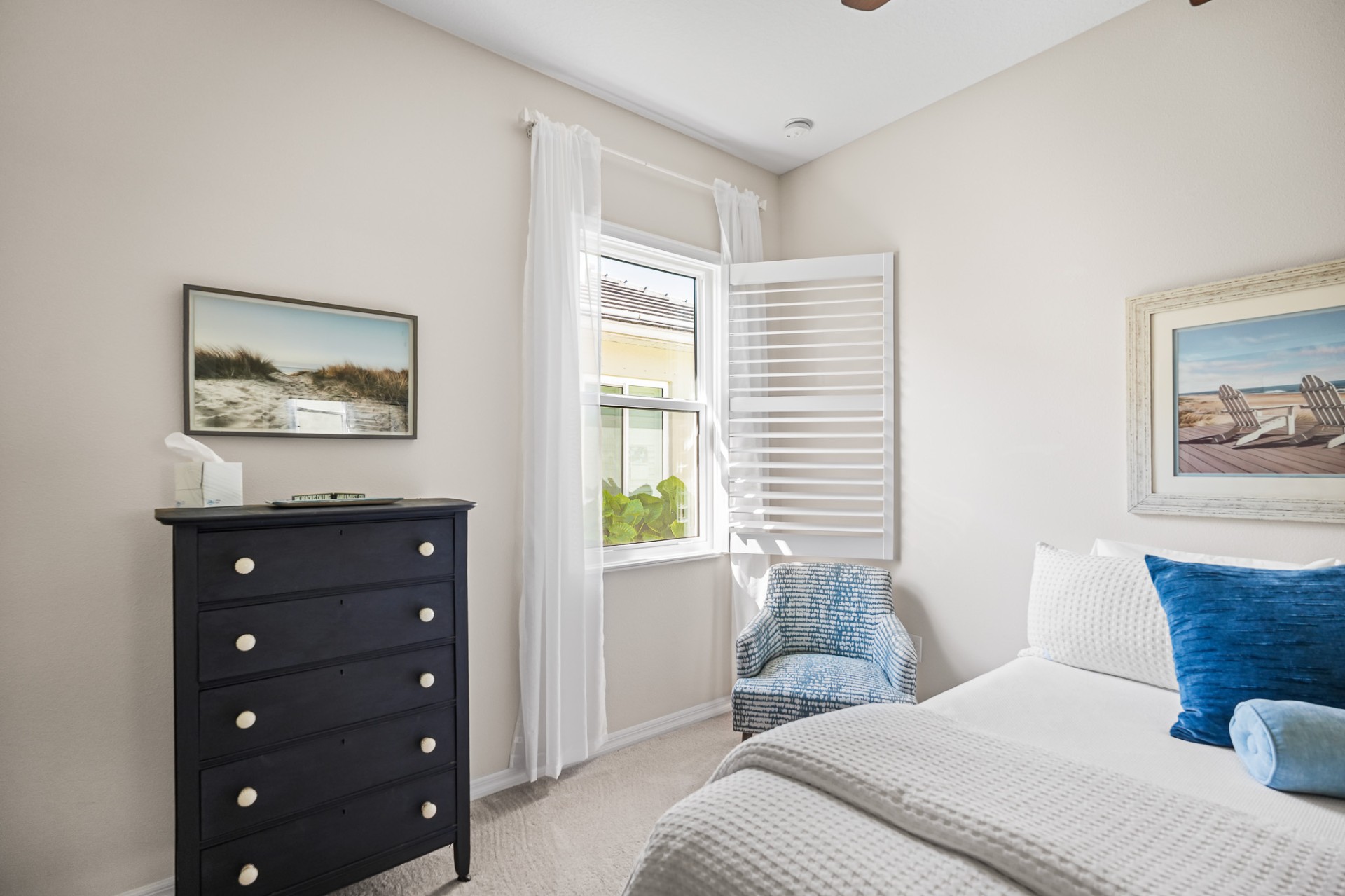 Coastal guest bedroom with new impact window and shutters